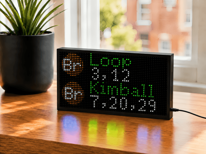 Chicago 'L' countdown clock showing live CTA Brown Line arrival times to Loop and Kimball on a tabletop LED display